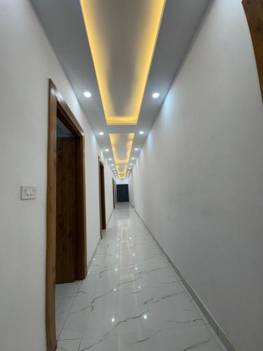 a corridor of an office building with a ceiling at The Lavish Hotel in Pīrthala