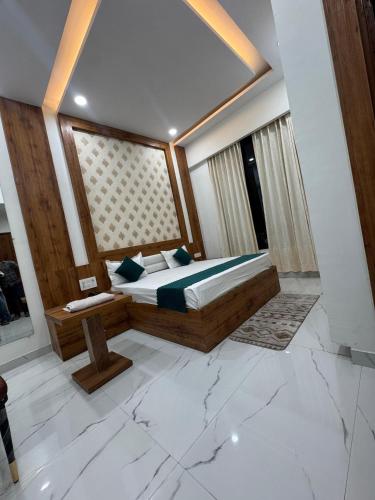 a bedroom with a bed and a large window at The Lavish Hotel in Pīrthala