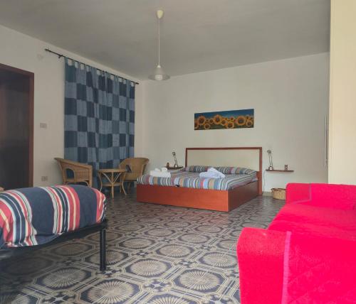 a bedroom with a bed and a couch at Happy House Corricella in Procida
