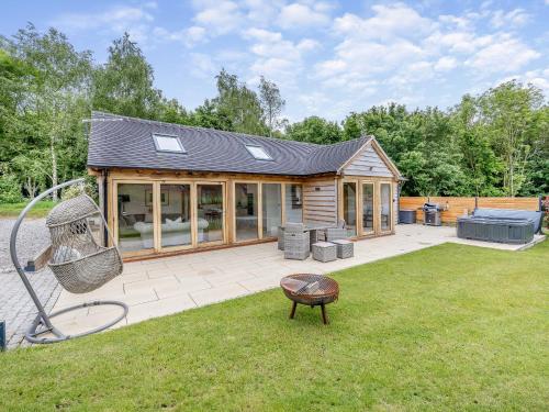 a house with a playground in a yard at Walford Lodge - Uk47305 in Uttoxeter