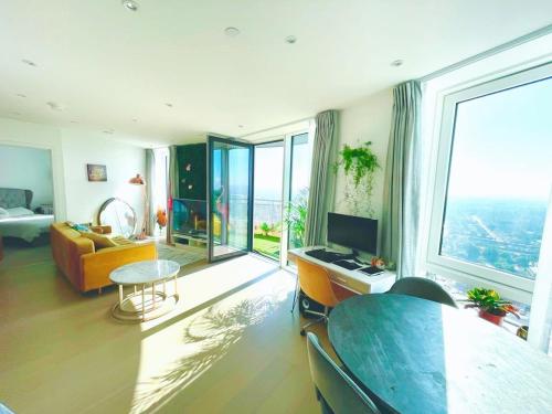 a living room with a couch and a table at Luxury 1-Bedroom Apt with Stunning London Views in Barking