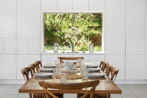 a dining room with a table and a window at Sunset Palms in Palm Beach