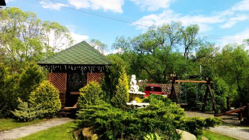 a garden with a gazebo with a statue at Laguna in Slavske