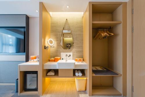 a bathroom with a sink and a mirror at Atour Hotel Beijing Asian Games Village National Convention Center in Beijing
