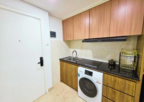 a kitchen with a washing machine and a sink at Apartment - 2 bedroom, 3 beds in Medan