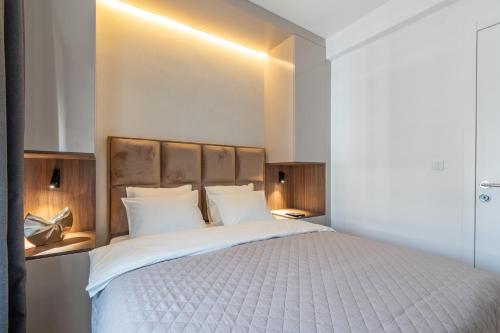 a bedroom with a large bed with white pillows at Park Vila Apartments in Belgrade