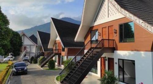 a row of houses with stairs in a parking lot at Hotel Niagara Parapat in Parapat