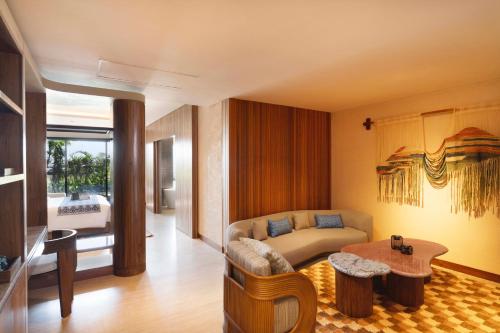 a living room with a couch and a table at TUI BLUE Berawa Hotel and Villas in Canggu