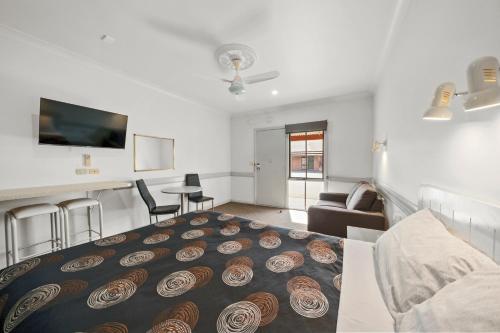a living room with a large bed in the middle at Centre Town Motel in Nagambie