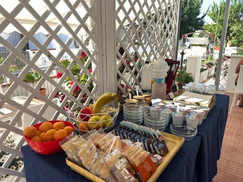 a table with a blue table cloth with food on it at Hotel La Meridiana in San Domino