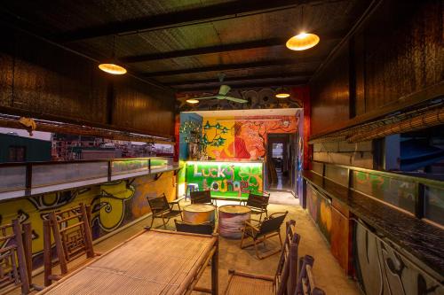 a restaurant with tables and chairs and graffiti on the wall at Hanoi Central Pod in Hanoi