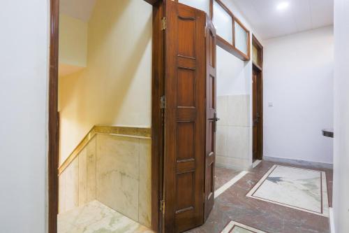 a hallway with an open door in a room at Hotel O Golden Key Rohini in New Delhi