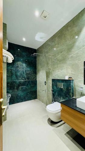 a bathroom with a toilet and a sink at Hotel Sagar haveli Bikaner in Bikaner