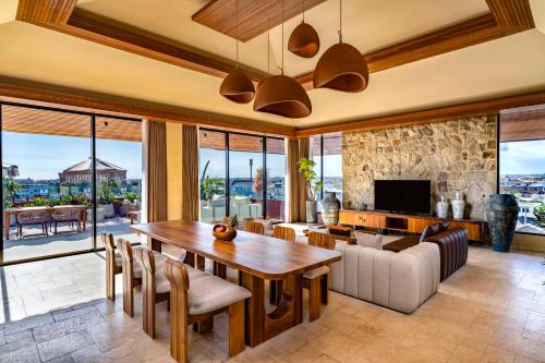 a living room with a table and a couch at TUI BLUE Berawa Hotel and Villas in Canggu