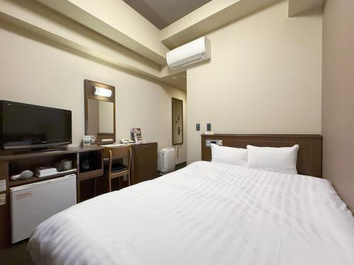 Ένα ή περισσότερα κρεβάτια σε δωμάτιο στο Hotel Route-Inn Hakata Ekimae -Hakataguchi-