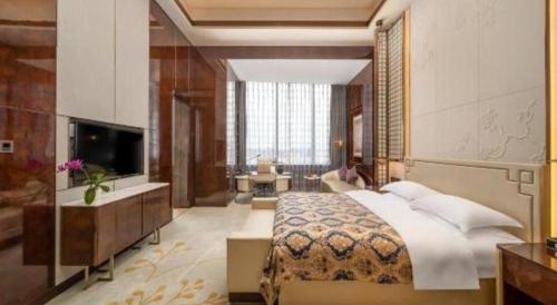 Ένα ή περισσότερα κρεβάτια σε δωμάτιο στο ZHONG DING HOTEL