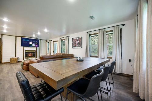 a living room with a large wooden table and chairs at Casino Close Hot Tub-Firepit-BBQ 2-acres Sleeps 6 in Broken Bow