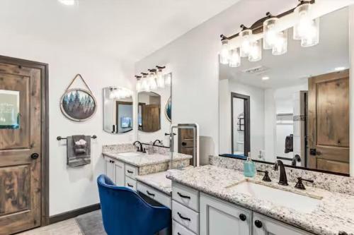 a bathroom with two sinks and two mirrors at Rock Creek Ranch in Show Low