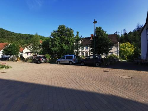 a parking lot with cars parked in a town at Pension im Tal der Stille in Treseburg