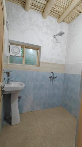a bathroom with a sink and a window at Balti hostel turtuk in Turtuk