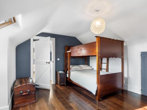 a bedroom with a wooden bunk bed in a room at Suantrai Cottage in Roundstone