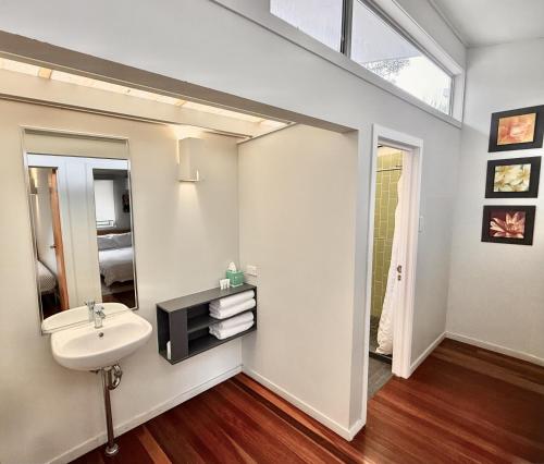a bathroom with a sink and a mirror at Allure Stradbroke Resort in Point Lookout