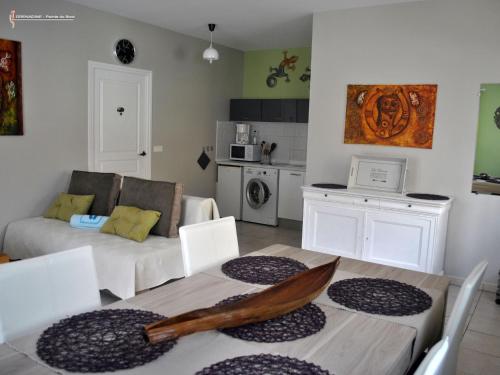 a living room with a couch and a table with a boat on it at CoCoKreyol - " GRENADINE " in Les Trois-Îlets