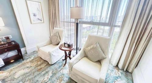 a hotel room with two chairs and a window at Xian Jue Vu Hotel in Xi'an
