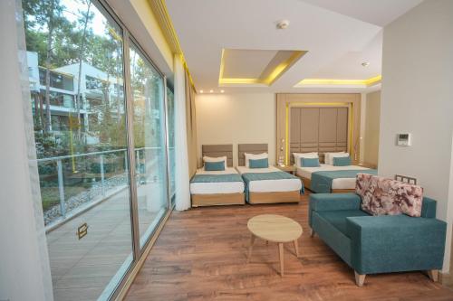 a living room with two beds and a couch at Orka Lotus Beach in Marmaris