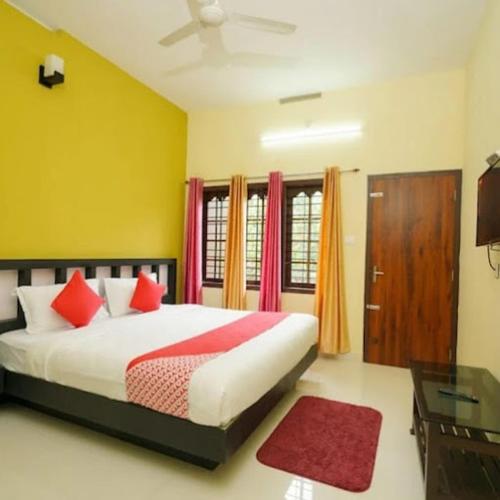 a bedroom with a bed with red pillows at Royalpark resort in Jāmb