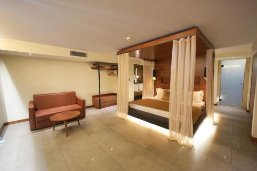 a bedroom with a bed and a couch and a chair at Orka Lotus Beach in Marmaris