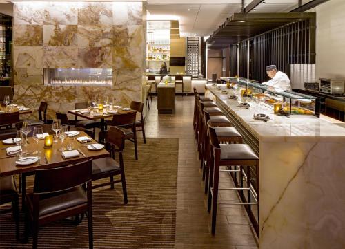 a restaurant with tables and a chef preparing food at Hyatt Regency Chicago in Chicago