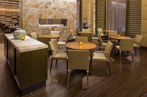 a restaurant with tables and chairs and a man in the background at Hyatt Regency Chicago in Chicago