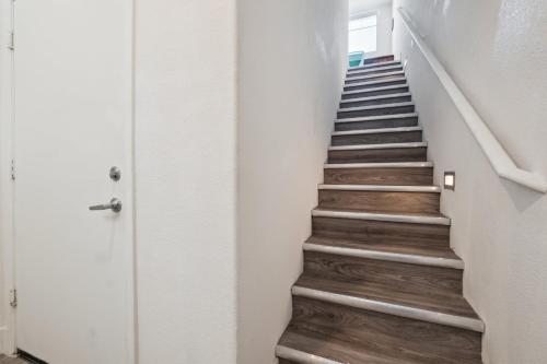 a staircase in a room with wooden floors at CozySuites Glendale - Westgate w pool 13 in Glendale