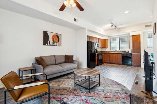 a living room with a couch and a kitchen at CozySuites Glendale - Westgate w pool 13 in Glendale