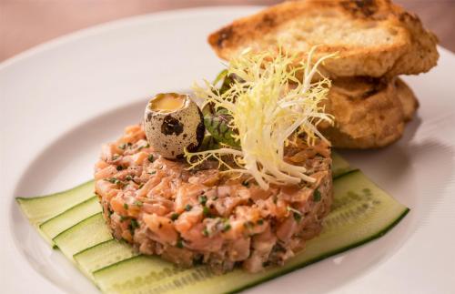 a white plate of food with meat and bread at Hyatt Regency Chicago in Chicago