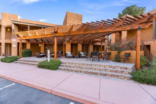 a pergola on a building with a patio at Arroyo Pinion Hotel, an Ascend Collection Hotel in Sedona