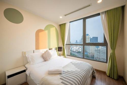 a bedroom with a white bed with a large window at LUNA Apartment - Luxury Residence Landmark 81 Area in Ho Chi Minh City