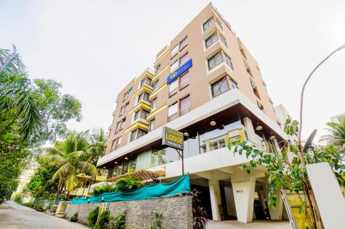 a tall building with a sign in front of it at FabHotel Sai Raj - Nr Zeel College in Pune