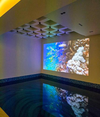 a room with an aquarium with a large fish tank at The White Suites in Karachi