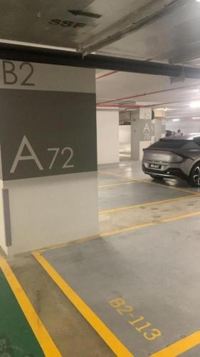 a parking garage with a car parked in it at KL Central 32 Floor KLCC View in Kuala Lumpur
