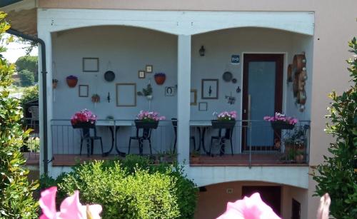 a front porch of a house with flowers at Casa Vintago b&b in Savio di Ravenna