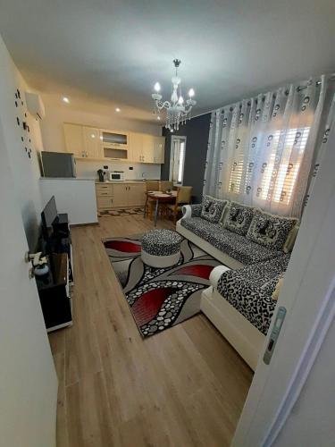 a living room with a couch and a table at Natan Home in Shkodër