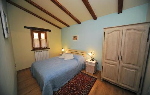 a bedroom with a bed and a cabinet and a rug at Villa Casa Natura Ucka - Opatija by Villas Guide in Mošćenička Draga