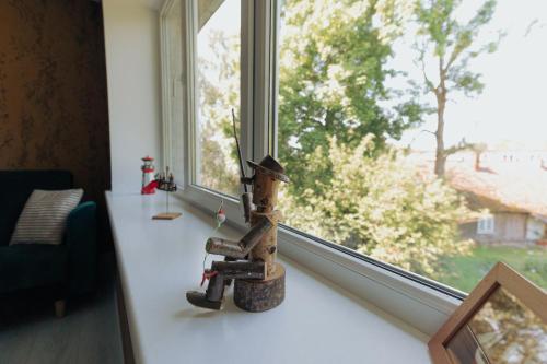 a wooden figurine sitting on a counter in front of a window at Apartment in Dreverna I Near Lagoon I in Dreverna