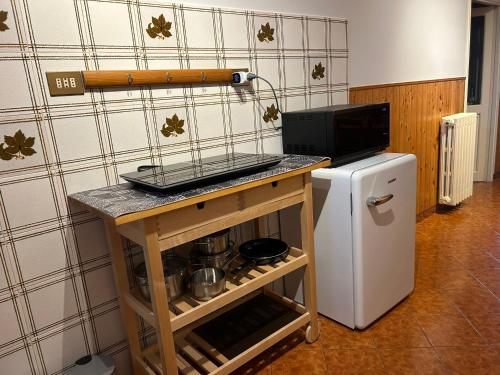 a kitchen with a counter and a small refrigerator at Casa Van Lente in Capranica