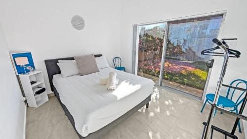 a bedroom with a bed with a teddy bear on it at Seashore Villa by Experience Jervis Bay in Vincentia