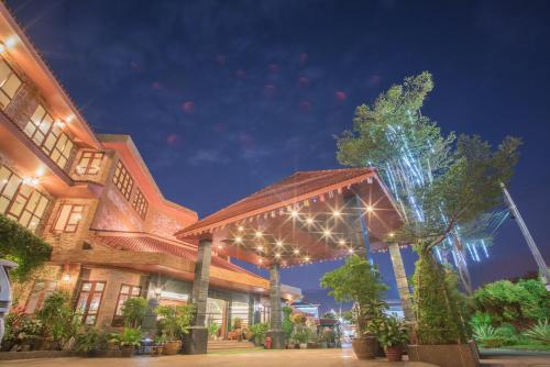 a building with lights on it at night at Busyarin Hotel in Nong Khai