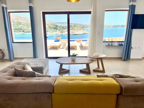 a living room with a couch and a table at SeaWave Villas, By Hellocrete in Chania Town