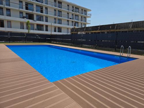 a swimming pool in front of a building at Nadmorski Apartament z Parkingiem by Rent like home in Sianozety